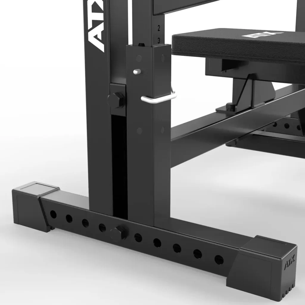 Close-up of the ATX® Olympic Bench Press 700, featuring a black metal adjustable frame with multiple hole settings, a locking pin, and a padded section. The brand name ATX is visible on the frame.