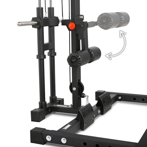 A close-up view of the ATX® Half Rack, a black gym machine with padded rollers and metal bars for leg exercises, features an arrow pointing to adjustable parts for customized workout positions.