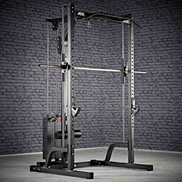 The ATX® Smith Machine System Stack Weight 115 kg, in black, is set up in a room with a textured gray brick wall. It features a pulley system, a barbell, adjustable safety bars, and various attachment points for workouts.