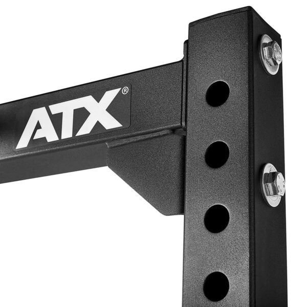 Close-up of a black ATX® Half Rack with logo visible, featuring multiple adjustable holes and shiny bolts.