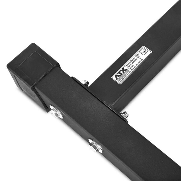 Close-up of a black metal corner bracket from the ATX® Half Rack featuring two bolted connections and a safety label, angular design with square tubing, and a rubber cap.