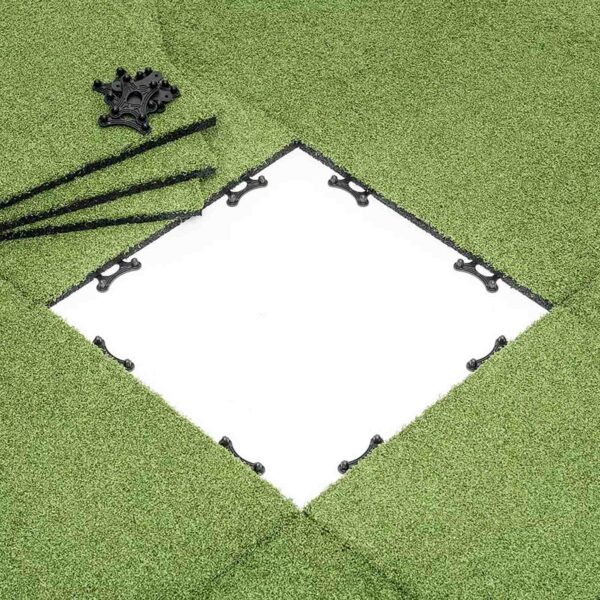 A section of GymFloor RTS 50x50@20mm turf features a central square cutout revealing a white surface. Black connectors and strips are arranged around the opening for assembly or installation.