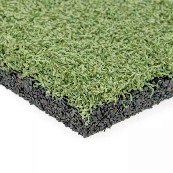 Close-up of GymFloor RTS 50x50@20mm System, showing the textured green synthetic turf layer over a black rubber base, highlighting the contrast between the lifelike grass top and sturdy foundation.
