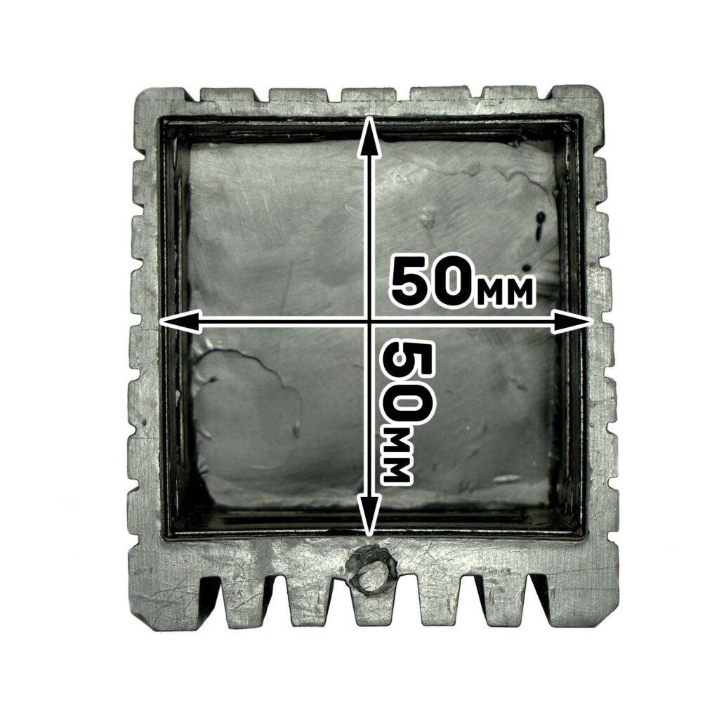 The Rubber Foot 50mmx50mm is a metallic mold with serrated edges on three sides, a bottom protrusion, and an interior measurement of 50mm x 50mm. The inner surface is textured and unfinished.