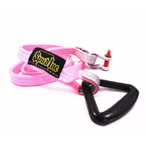 The Spud Inc Sled Attachment Strap PINK features a black triangle-shaped buckle, a black patch with yellow text, and a small metallic red accent on one end.