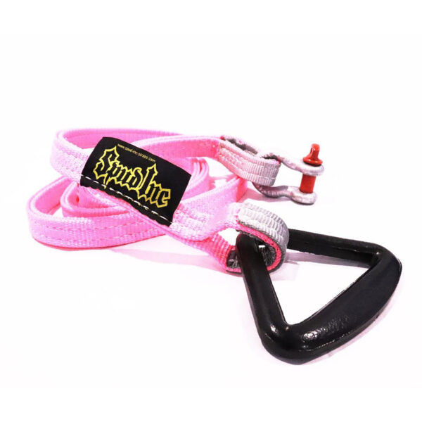 The Spud Inc Sled Attachment Strap PINK features a black triangle-shaped buckle, a black patch with yellow text, and a small metallic red accent on one end.