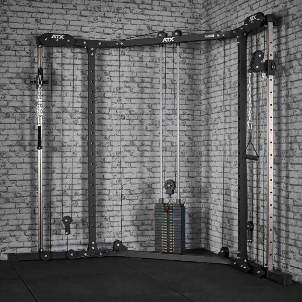 A home gym setup featuring the ATX® Cable Crossover Weight Stack 90 kg against a brick wall, equipped with adjustable pulleys for versatile upper body exercises, and a floor covered in black foam tiles.