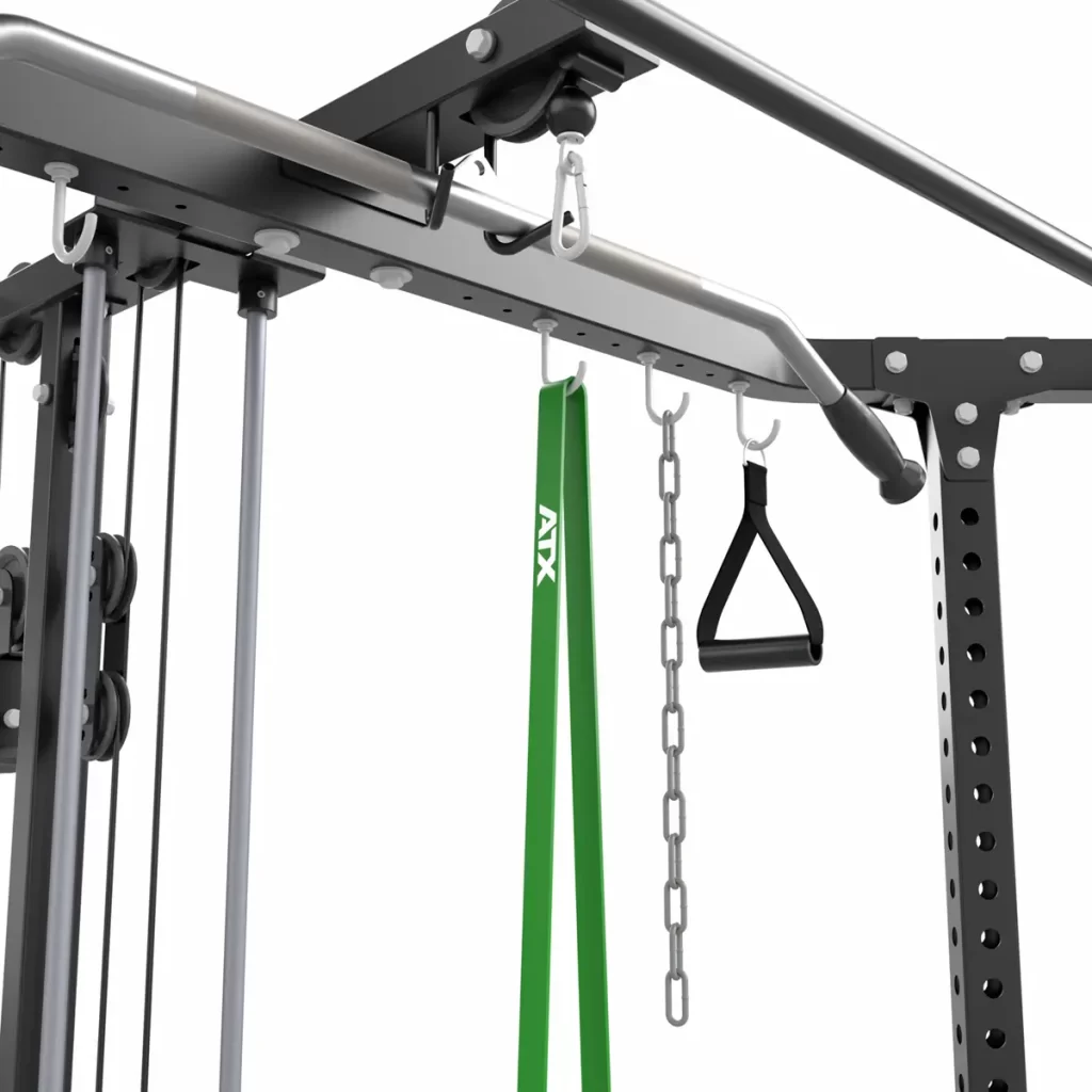 Close-up of the ATX® Cable Corner Station featuring attachments like a green resistance band, metal chain, and black handle strap. This robust setup is ideal for strength training exercises.