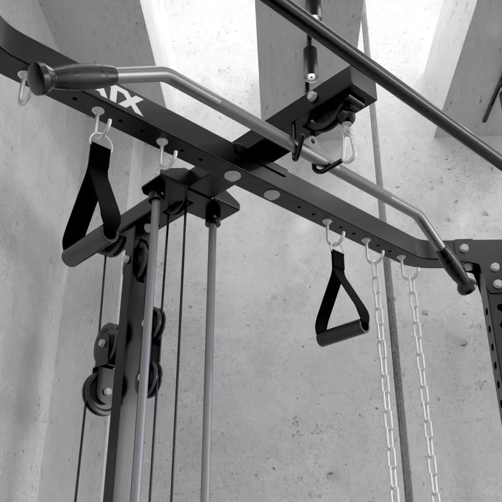 Close-up of a home gym setup showcasing the ATX® Cable Corner Station. It features a multi-grip pull-up bar, resistance bands, and handles, mounted on its sturdy frame against a concrete ceiling background to highlight its versatility for different exercises.
