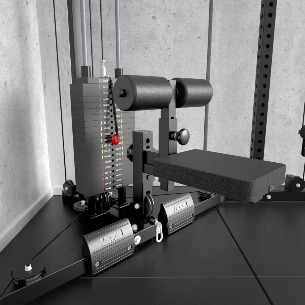 The ATX® Cable Corner Station features a sturdy metal frame, weight stack with numbered plates for easy adjustments, and a padded leg extension attachment. It fits perfectly in the corner against a concrete wall.