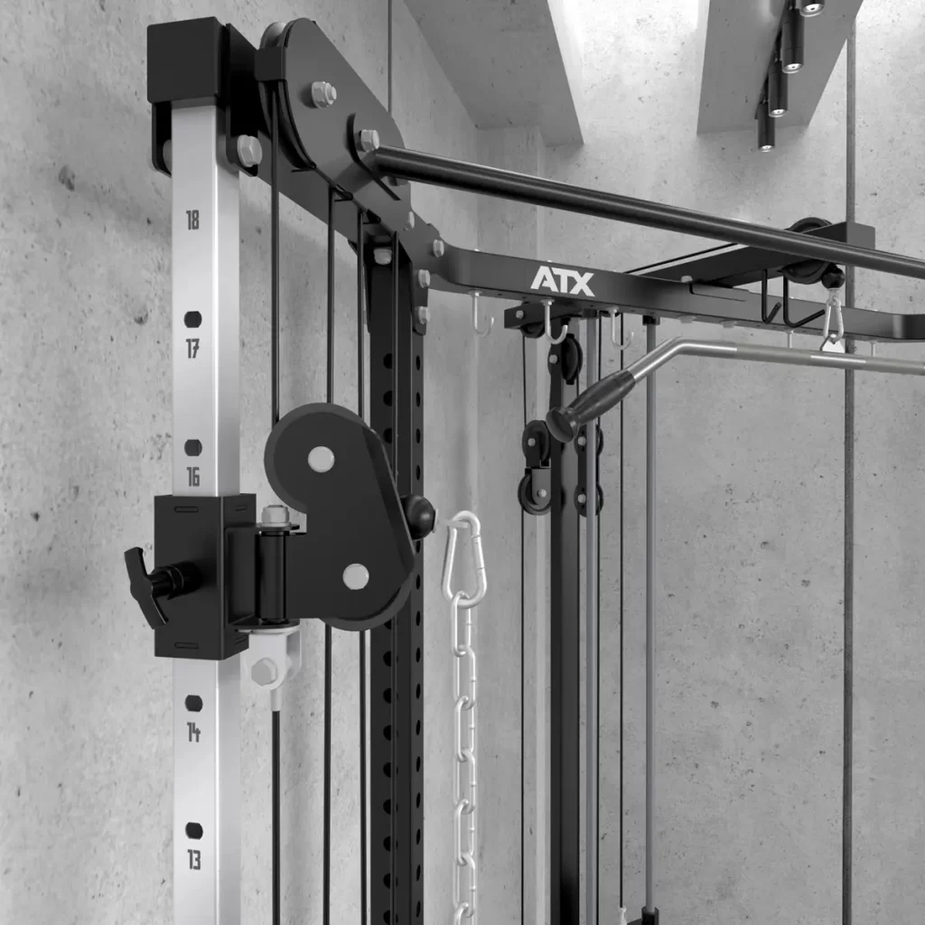 Close-up of the ATX® Cable Corner Station featuring sleek pulleys and weight settings. Mounted on a concrete wall, it boasts black and silver components with ATX branding prominently displayed at the top.