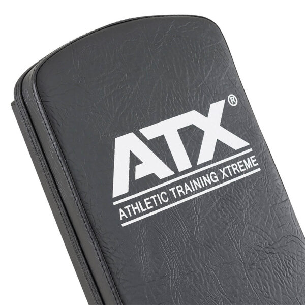 Close-up of a black padded ATX® Utility Bulls Bench featuring the white text ATX Athletic Training Xtreme on its smooth, slightly shiny surface.