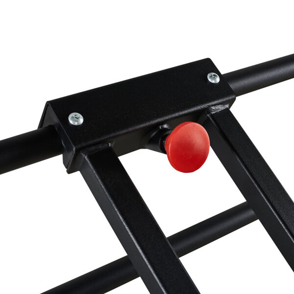 Close-up of the ATX® Wall Bar Gym, a black metal structure reminiscent of Swedish Bars, featuring a striking red button in the center. The frame is bolted, highlighting the vibrant button against the dark metal.