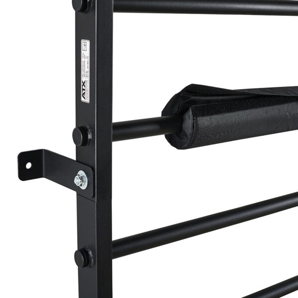 Close-up of the ATX® Wall Bar Gyms black metal structure, featuring multiple horizontal bars and a padded cover wrapped around one. The wall-mounted Swedish Bars are secured with visible bolts and a sticker on the frame.