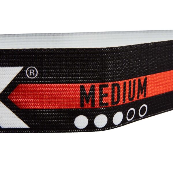 Close-up of the ATX® Loop Band in black with a red stripe, featuring the word MEDIUM in bold letters. The design includes white circles and an arrow pointing to the left, making it part of a versatile set perfect for various workout routines.