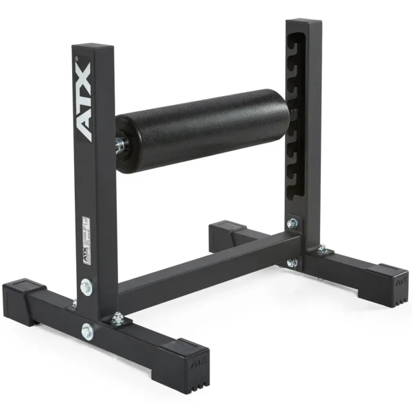 The image showcases the ATX® Split Squat Stand in black, featuring a sturdy frame with a cylindrical padded roller at the center. Its perfect for leg or back exercises and has a robust rectangular base to ensure maximum stability during workouts.