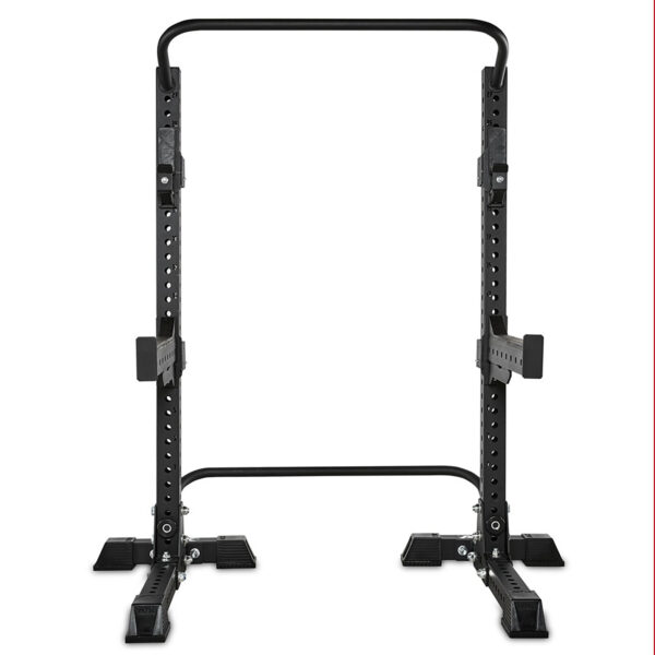 The ATX® Squat Stands Brace is a black, adjustable squat rack featuring safety spotter arms and numerous height adjustment holes. Its base has wide feet for stability, all set against a plain white background.