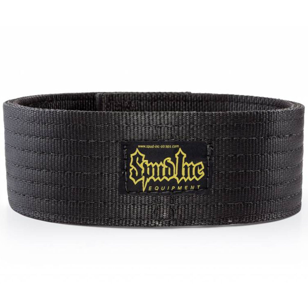 The Spud Inc Pro Strongman Belt is black with a textured pattern, featuring a yellow Syndicate Equipment logo patch on the front and appears to be made from durable material.