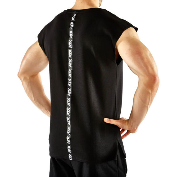 A person wears the ATX® Muscle Shirt, a sleeveless black top with a vertical ATX logo strip down the back, paired with black shorts, standing hands on hips against a plain white background.