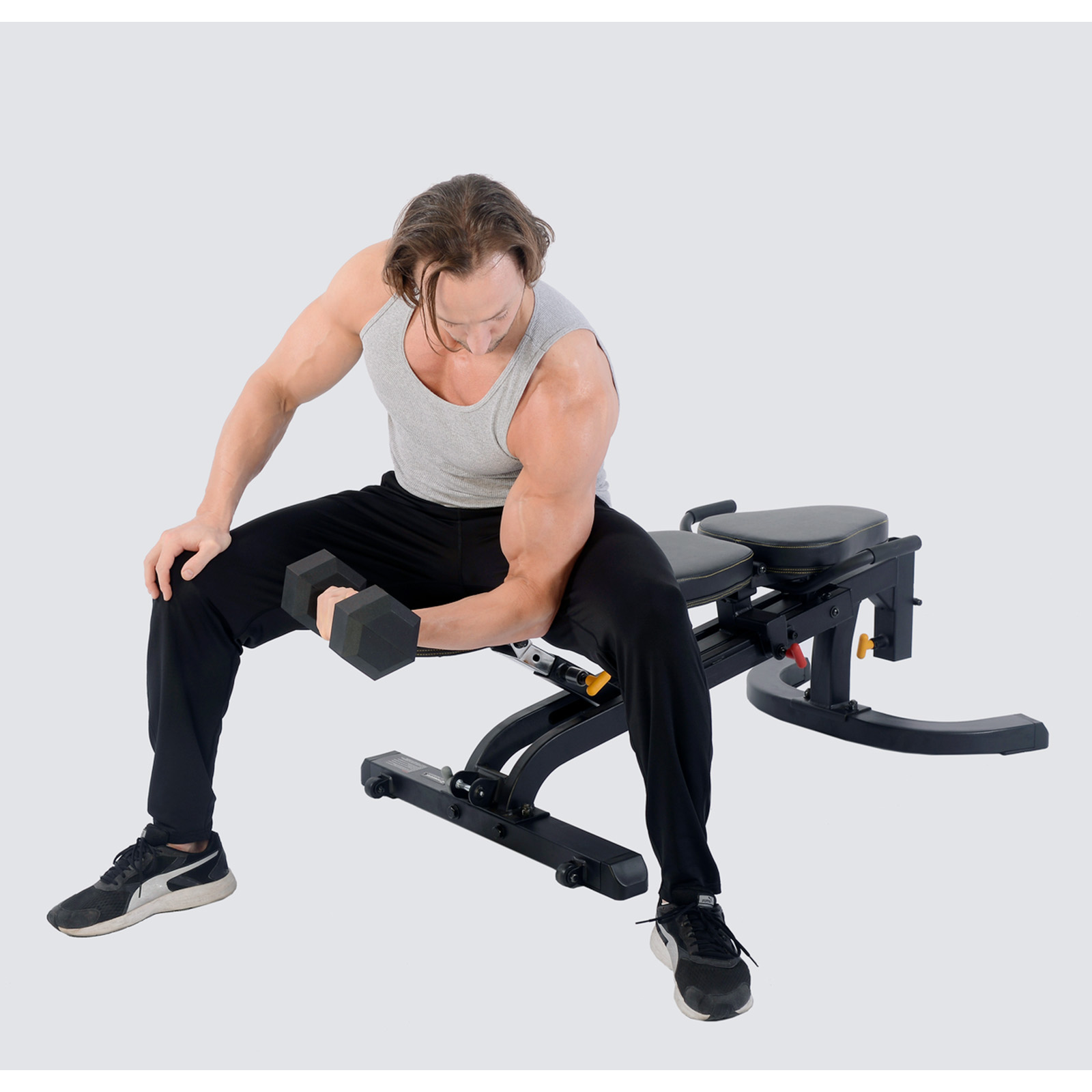 A man doing concentration curls on the bench