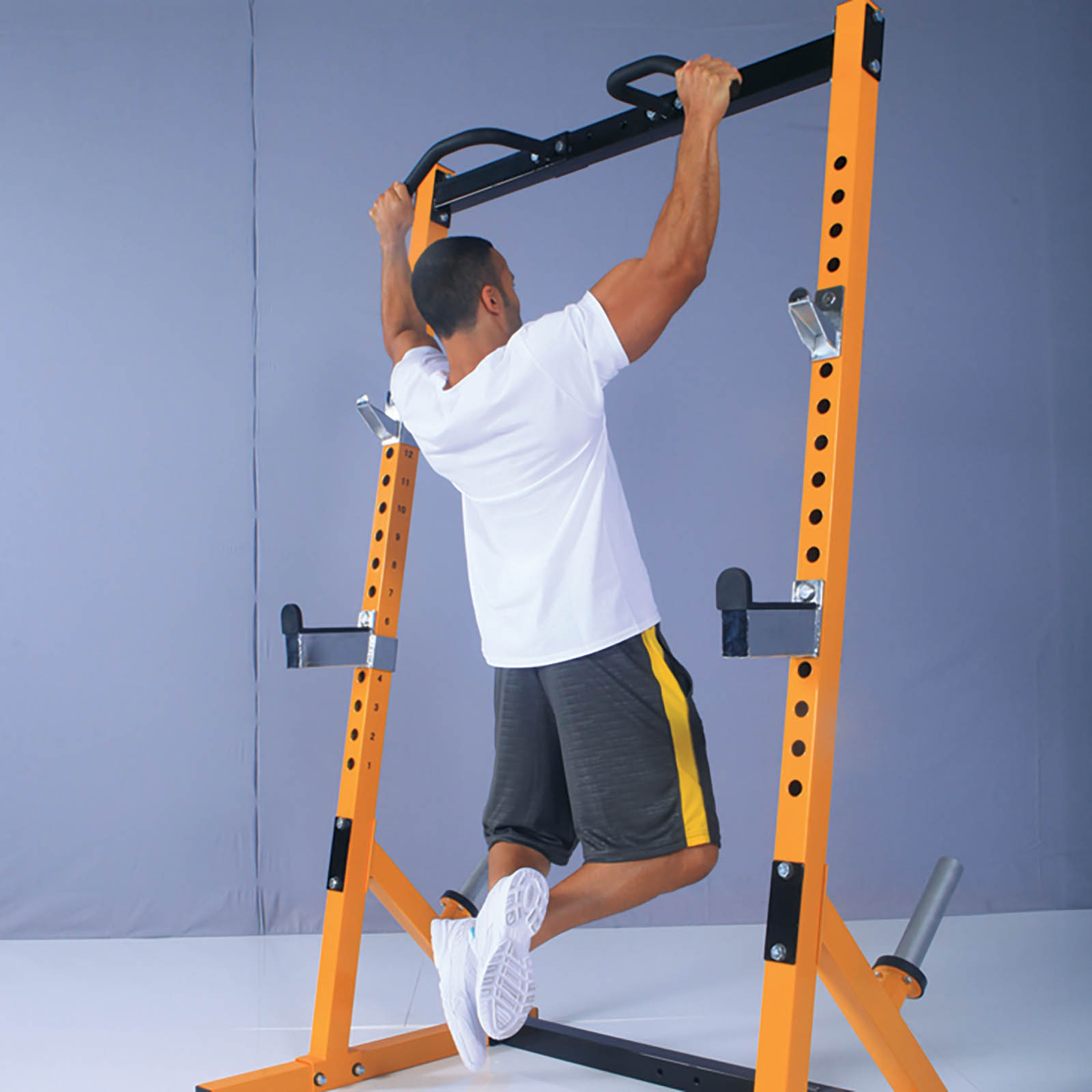 Man doing chin ups on a Powertec half rack