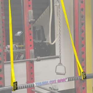 A gym setup featuring a Spud Pittsburgh Jammer with a Fat Bar on yellow straps in a red rack, plus a chain handle. Exercise equipment is visible in the background.
