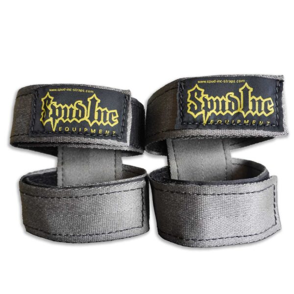 The Spud Inc 5R Barbell Shield features gray fabric wrist straps with black patches and yellow Spud Inc branding, designed for fitness or weightlifting, secured with Velcro closures.