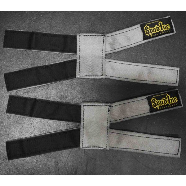 Two Spud Inc 5R Barbell Shields in gray and black with yellow branding on a dark surface, each featuring a loop and velcro closure for secure attachment.