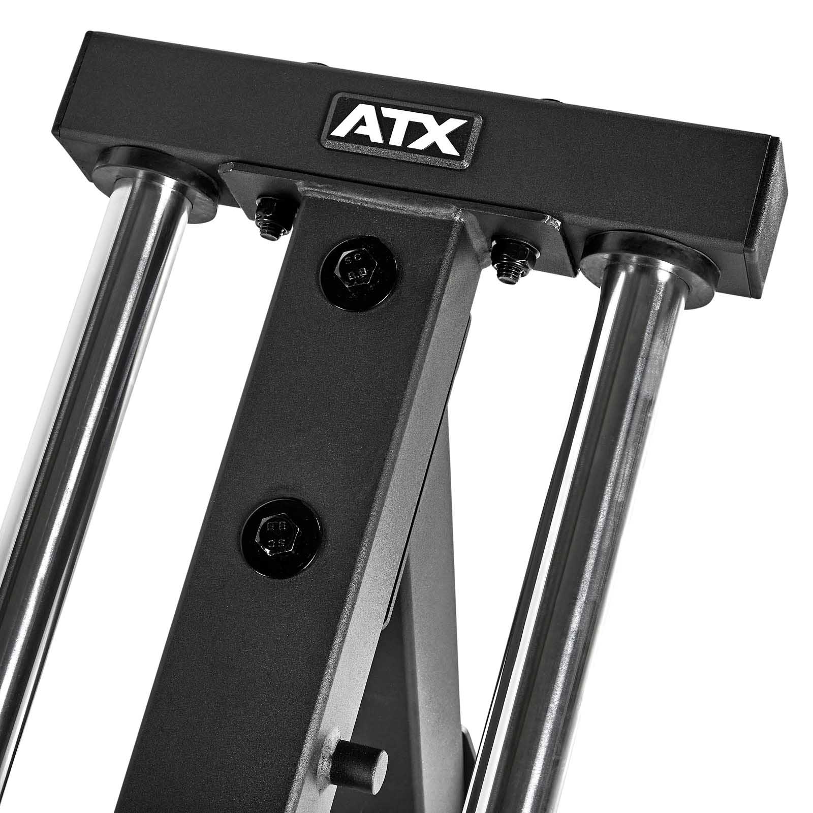 Close-up view of a black and silver ATX Compact Leg Press fitness component, featuring sturdy metal bars and bolts. The brand logo ATX is prominently displayed on the top piece, emphasizing its sleek design.