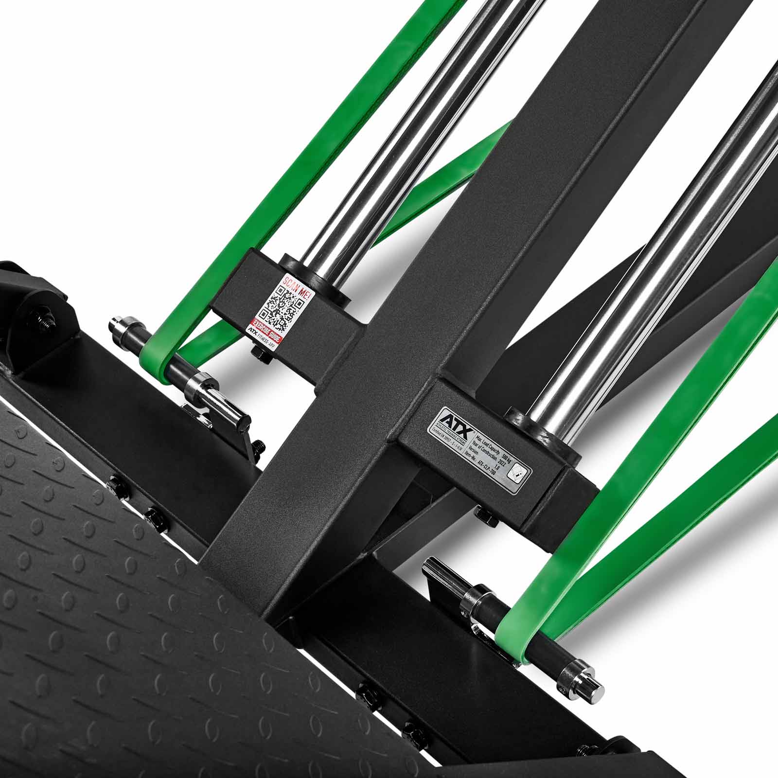 Close-up of the ATX Compact Leg Press showcasing its metal rods, green resistance bands, and a textured black platform. A label with branding and a QR code adds detail to this efficient sled leg press equipment.