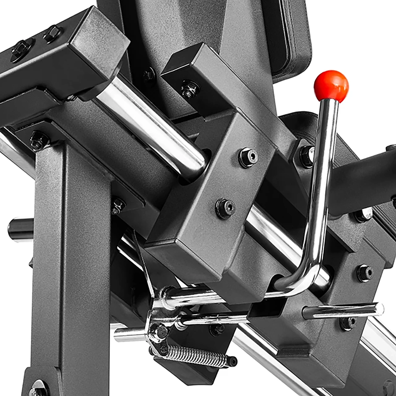 Close-up of a black metal gym machine with silver and red components, resembling an ATX Compact Leg Press. The image highlights a lever with a red grip, adjustable parts, and a spring. The sled leg press equipment is designed for exercise or weightlifting.