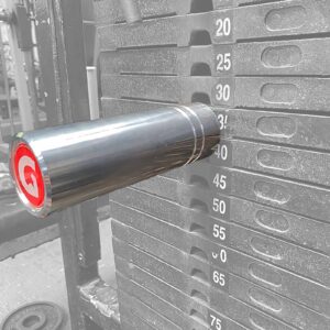 A close-up of the GymPin 2 Original inserted at the 40-lb level in a grayscale weight stack highlights its metallic pin and striking red logo. Visible weight increments range from 20 to 65 pounds, facilitating precise workout tracking.