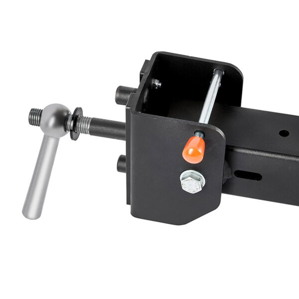 Close-up of the ATX® Belt Squat Option showing a black metal lock mechanism with a silver handle, visible nut, and bolt. An orange safety indicator is on the side, designed to ensure trailer security when hitched to vehicles.