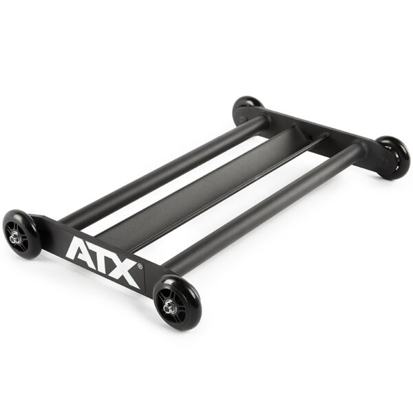 The ATX® Glute Ham Roller is a black roller dolly designed with two parallel bars and four wheels, making it perfect for effortlessly moving heavy gym equipment. Ideal for positioning machines like a GHR machine or core hamstring roller, the ATX logo is prominently displayed on the side.