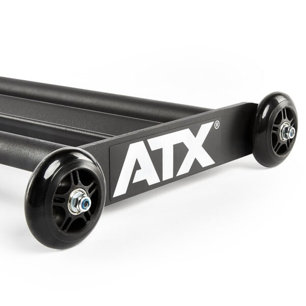 A close-up of a black ATX® Glute Ham Roller showcases two robust wheels and a sturdy metal frame, set against a plain white background.