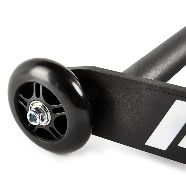 Close-up of a black ATX® Glute Ham Roller wheel attached to a sleek metal frame, featuring a white graphic design. The wheel, reminiscent of the product itself, has visible spokes and a shiny central bolt.