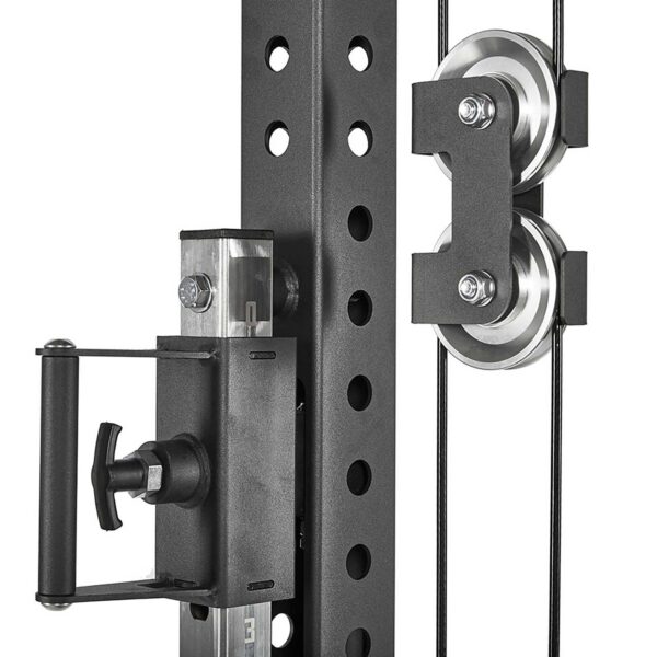 A close-up of the ATX® Trinity Tower 135 kg showcases a black cable pulley system on a metal exercise rack, featuring two metal pulleys with cables and a handle with an adjustable knob on the left.