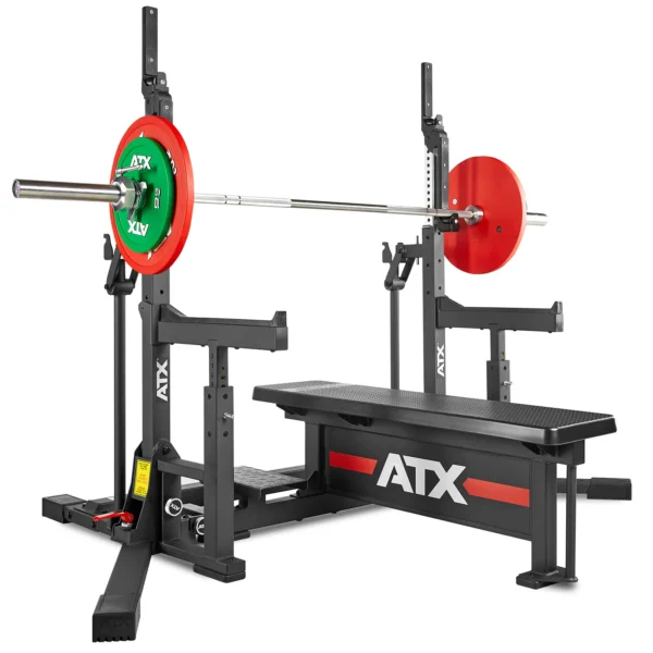 Powerlifting bench featuring an ATX brand barbell and colorful weight plates, designed as a competition bench press on an IPF combo rack. The set includes safety supports and adjustable components for weightlifting exercises.