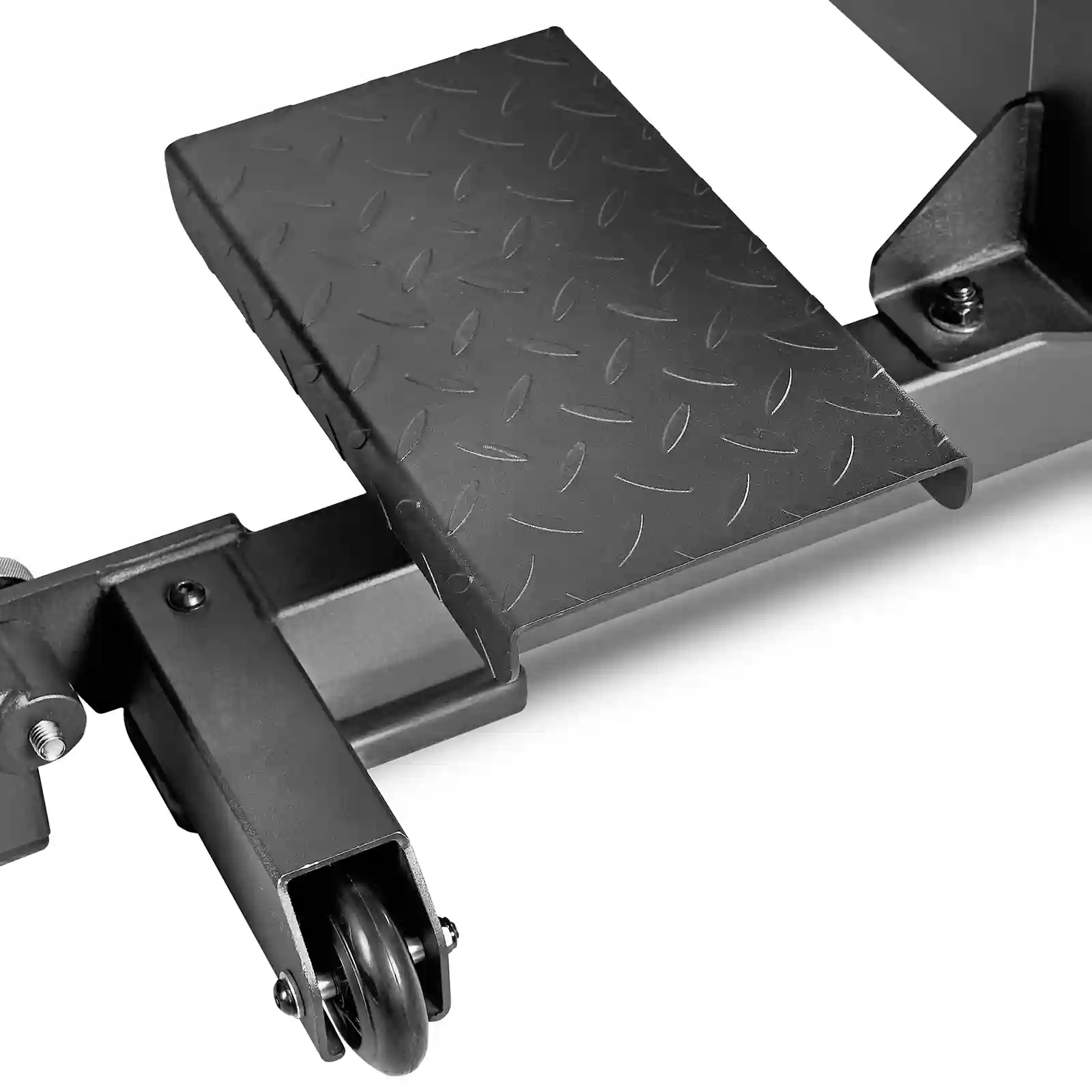 Close-up image of a metal step with a diamond plate pattern, part of an IPF combo rack. The black metal appears sturdy and is assembled with bolts. Nearby, a small caster wheel adds mobility to the structure, perfect for accommodating both competition bench press and squat rack exercises.