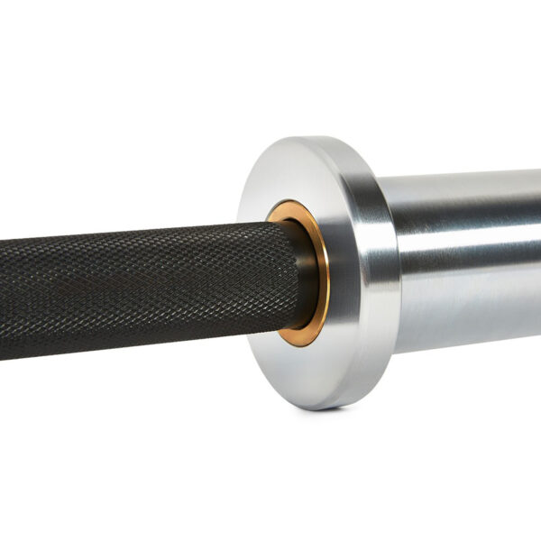Close-up of the ATX® Ram Powerlifting Bar II IPF shows its metallic silver sleeve with a distinctive bronze-colored ring and black knurled handle, all set against a plain white background, highlighting its minimalistic and polished design.