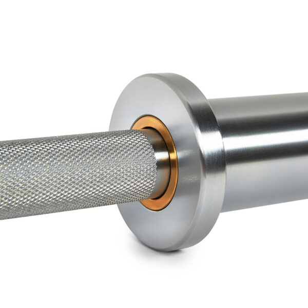Close-up of the ATX® Warrior Power Bar IPF featuring a silver barbell with a knurled grip and smooth sleeve, complete with a golden collar at its base to enhance the sleek, professional design.