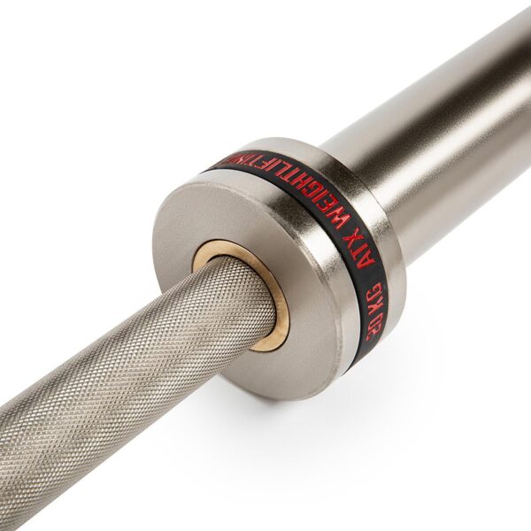 Close-up of a silver ATX® Training Weightlifting Bar with knurled grip and black end cap featuring red text 20KG MAX WEIGHTLIFTING, set against a plain white background.