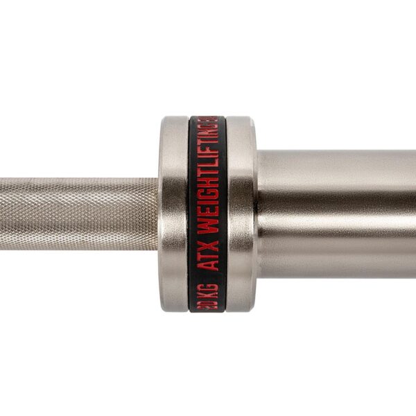 Close-up of the ATX® Training Weightlifting Bar, showcasing its silver finish and knurled grip for better hold. It features a black and red ring with ATX WEIGHTLIFTING text, emphasizing the brands sleek design.