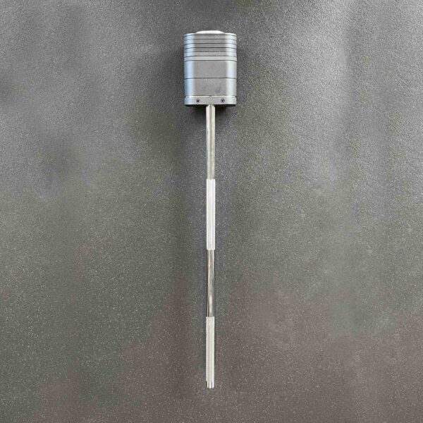 The Ironmaster Quick Lock Mace Handle is a tall, cylindrical metallic object featuring two sleek rods extending downward, displayed on a textured gray background.