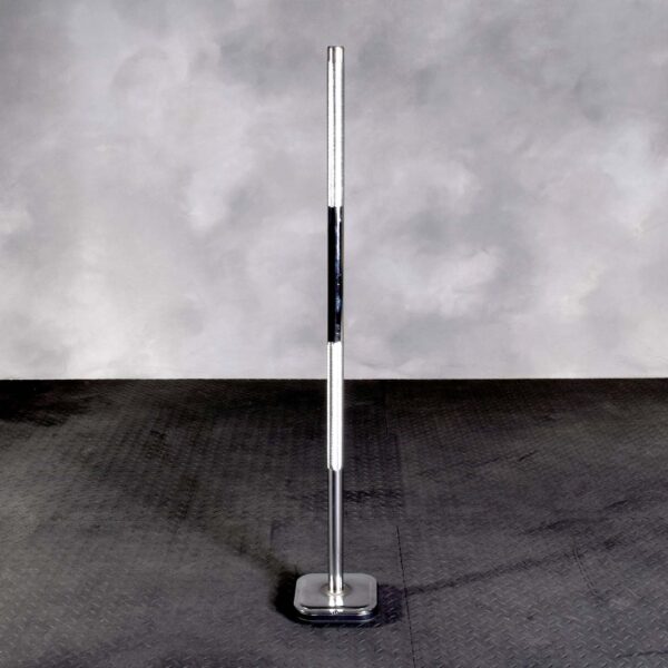 The Ironmaster Quick Lock Mace Handle stands upright on a textured gym floor against a neutral gray background, featuring a sleek design with visible knurling and is noted for its shiny metallic finish.