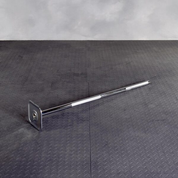 An Ironmaster Quick Lock Mace Handle with a square metal base on one end is lying on a dark, textured floor in a gray room.