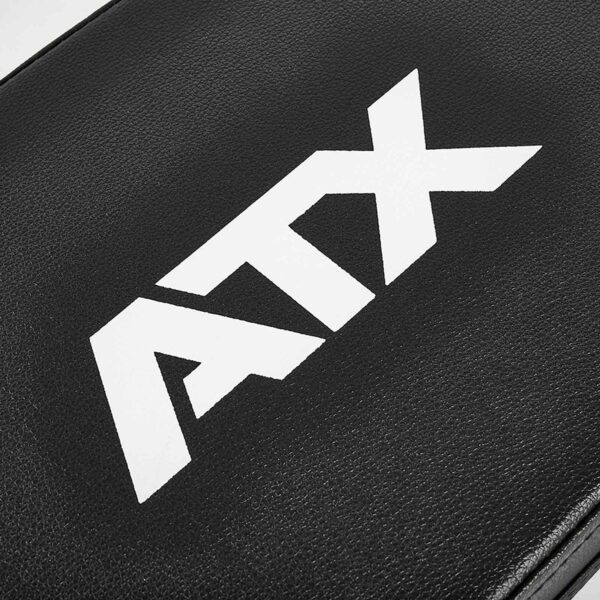 Close-up of a black ATX® Hip Thruster Attachment surface with bold white ATX letters, resembling a durable leather-like texture.