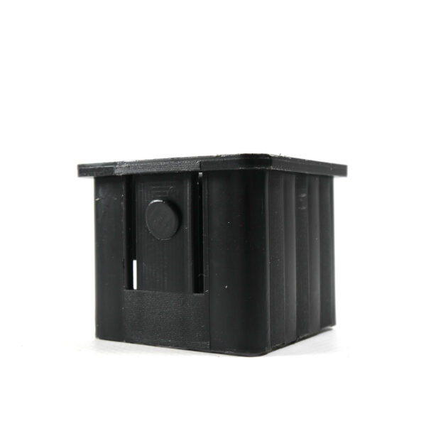 A compact black rectangular plastic box features ribbed sides and a circular protrusion on one side, displayed against a white background. This product is the Upright Sleeve Insert 40x40.