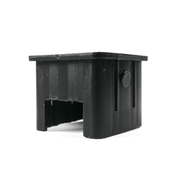 The Upright Sleeve Insert 40x40 is a black, plastic rectangular cap featuring a hollow center and a small circular protrusion on one side, with a slightly textured surface.