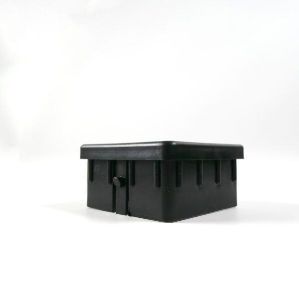 The Upright Sleeve Insert 75x75 is a black rectangular plastic container with a lid, adorned with small notches along the sides. Its showcased on a white background and angled slightly to the left.
